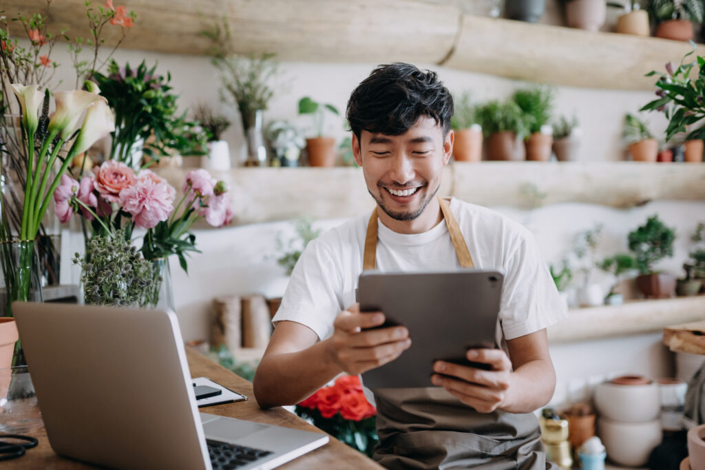 Small business owner with tablet and laptop